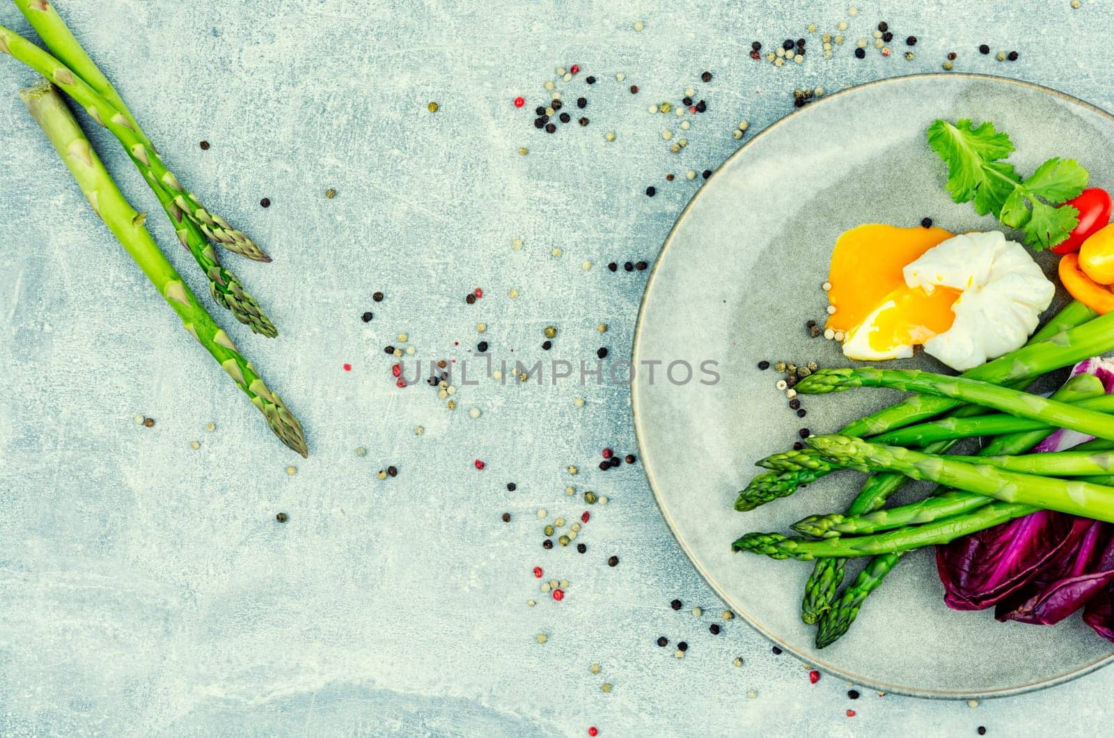 Tasty salad with asparagus, lettuce and poached egg.Copy space