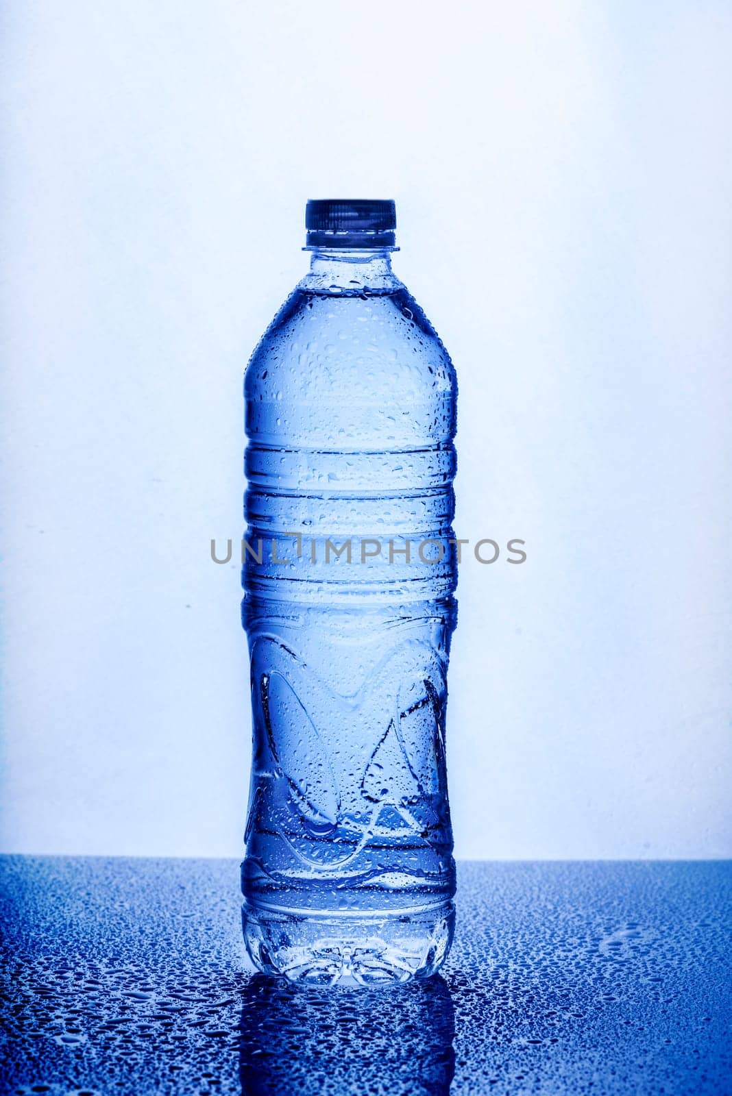 Fresh drinking mineral water in plastic bottle on white background. Healthy living concept.