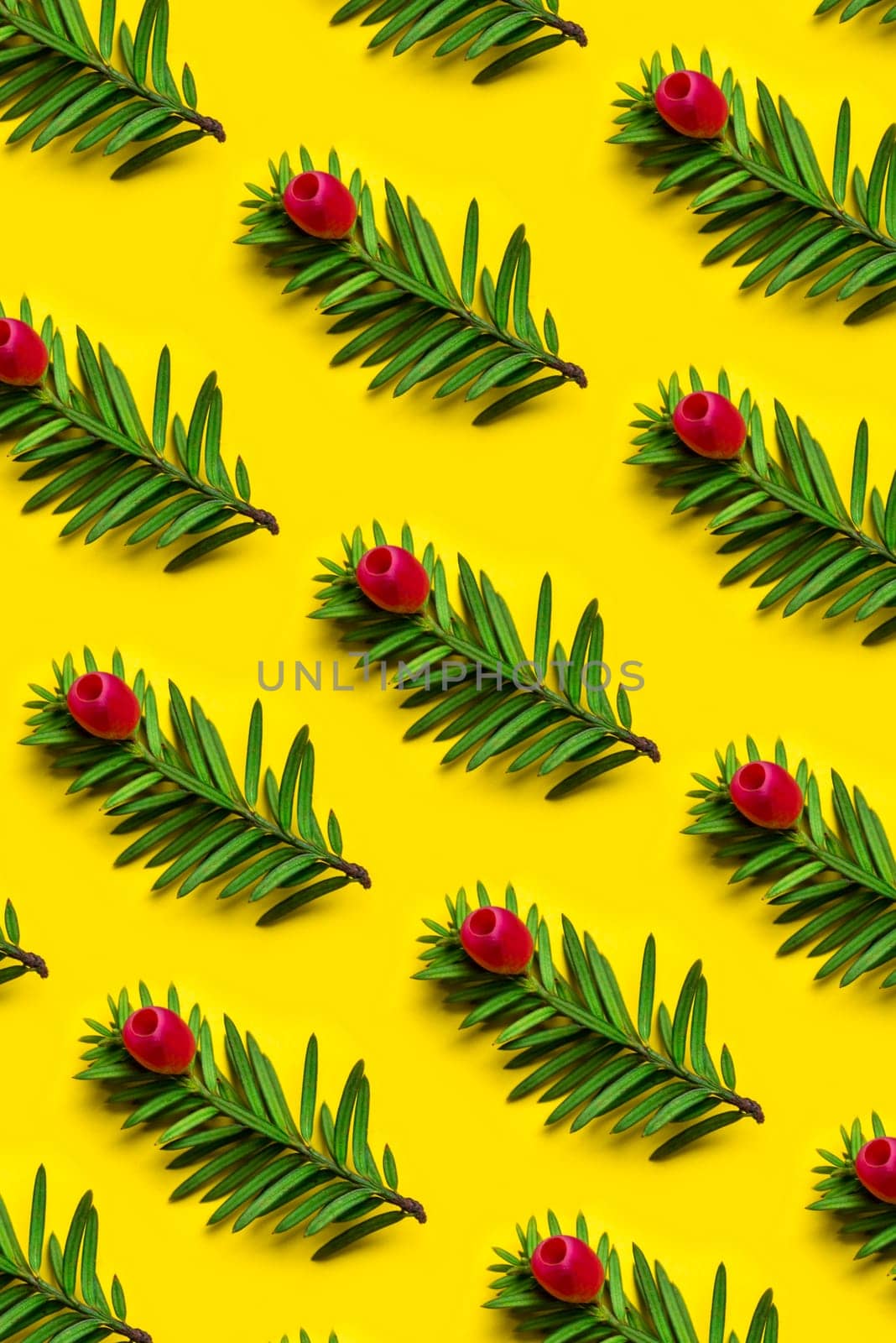 Christmas holiday pattern background. Christmas tree with red decor over pastel yellow background. Top view. Merry christmas and happy new year for 2019.