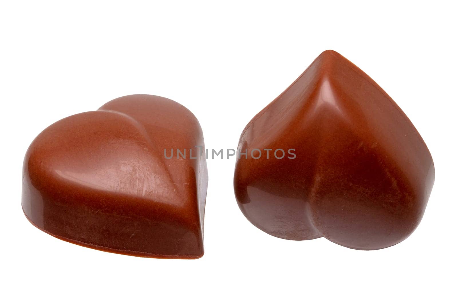 Fine milk chocolate chocolates in the shape of a heart isolated on a white background. Macro.