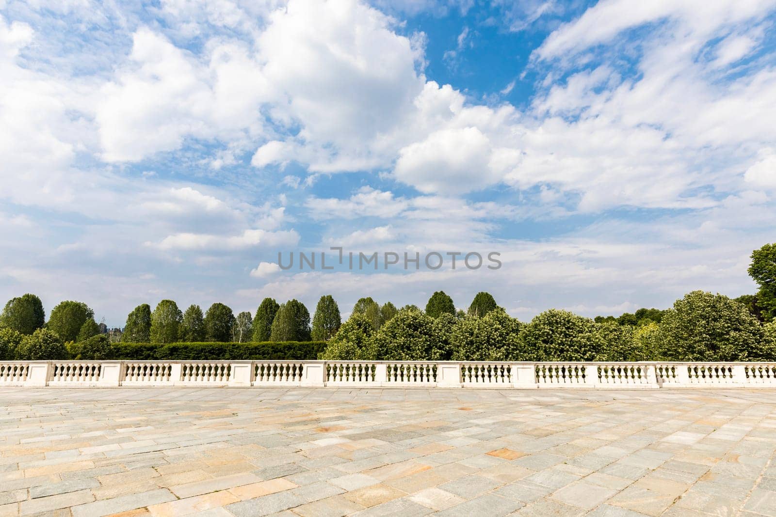 Exterior with old grey floor made of stone. Vintage textured pavement and blue sky in the background.