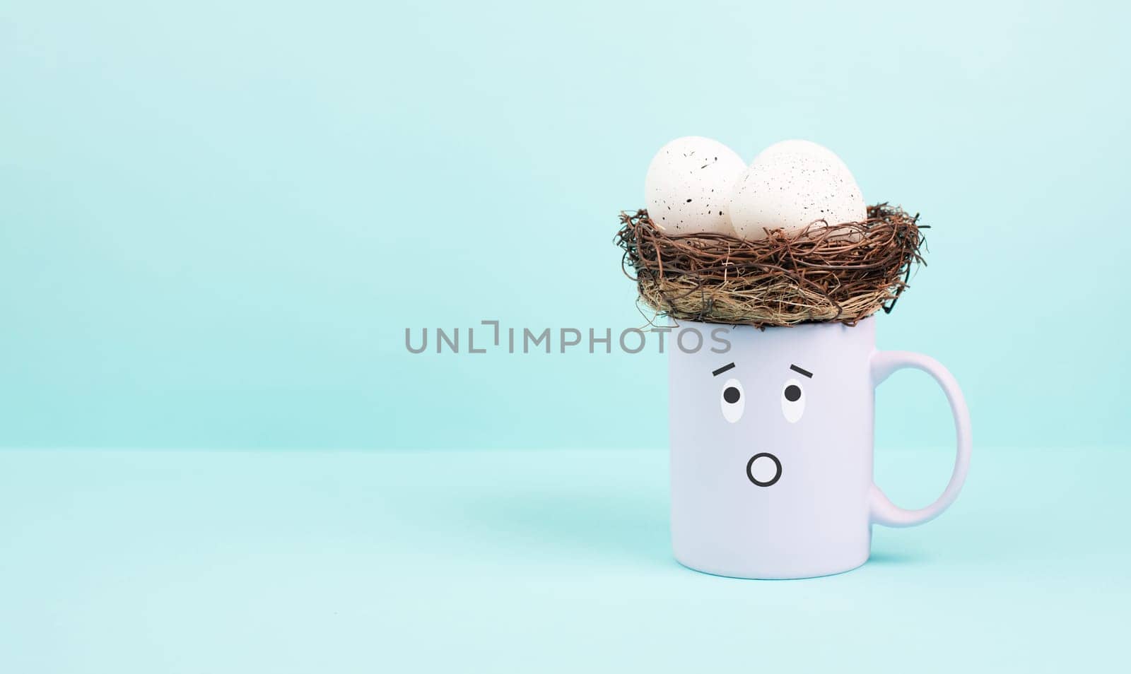 Cup with an easter egg nest, surprised face, spring holiday greeting card