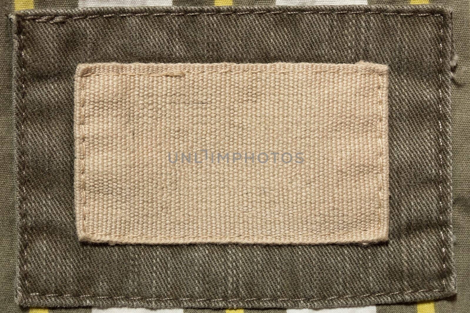 Empty beige fabric patch on men's trousers