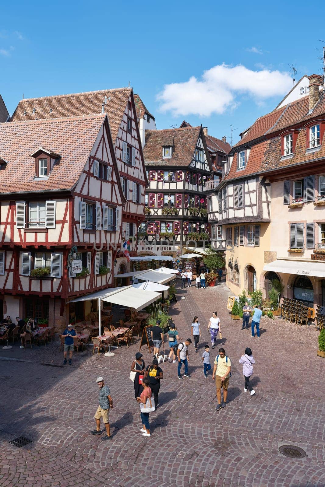 Tourists from all over the world in the picturesque medieval old town of Colmar in France