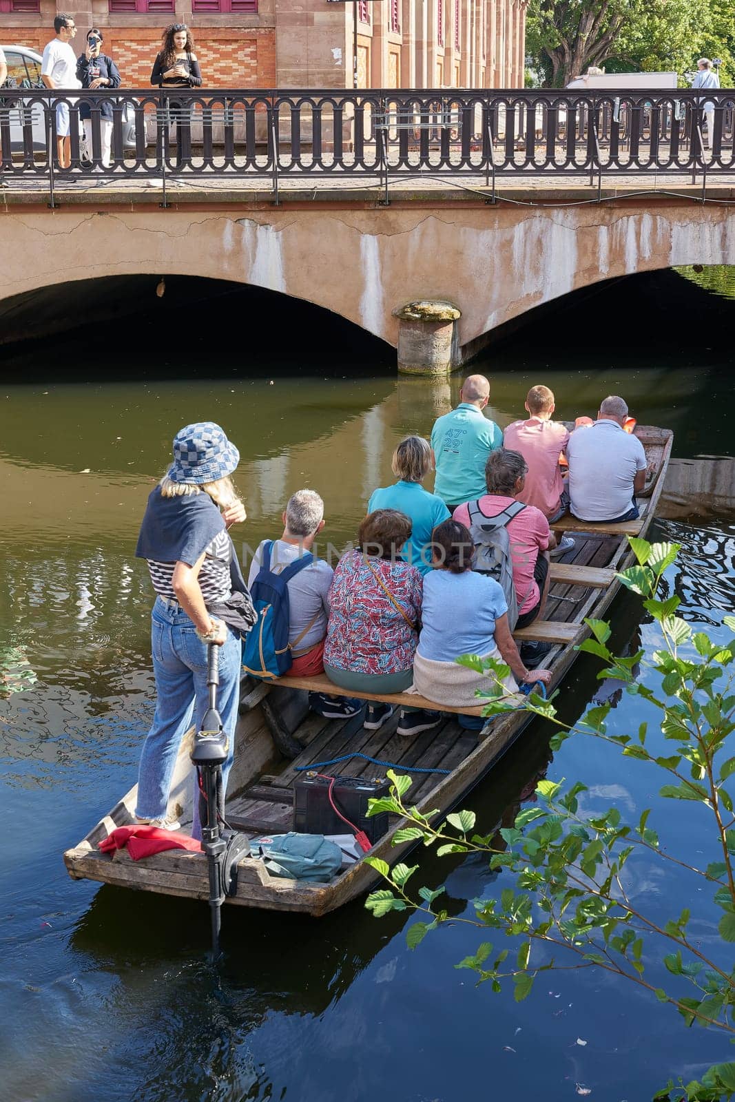 Tourists during a boat trip on the river Lauch in the old town of Colmar in France