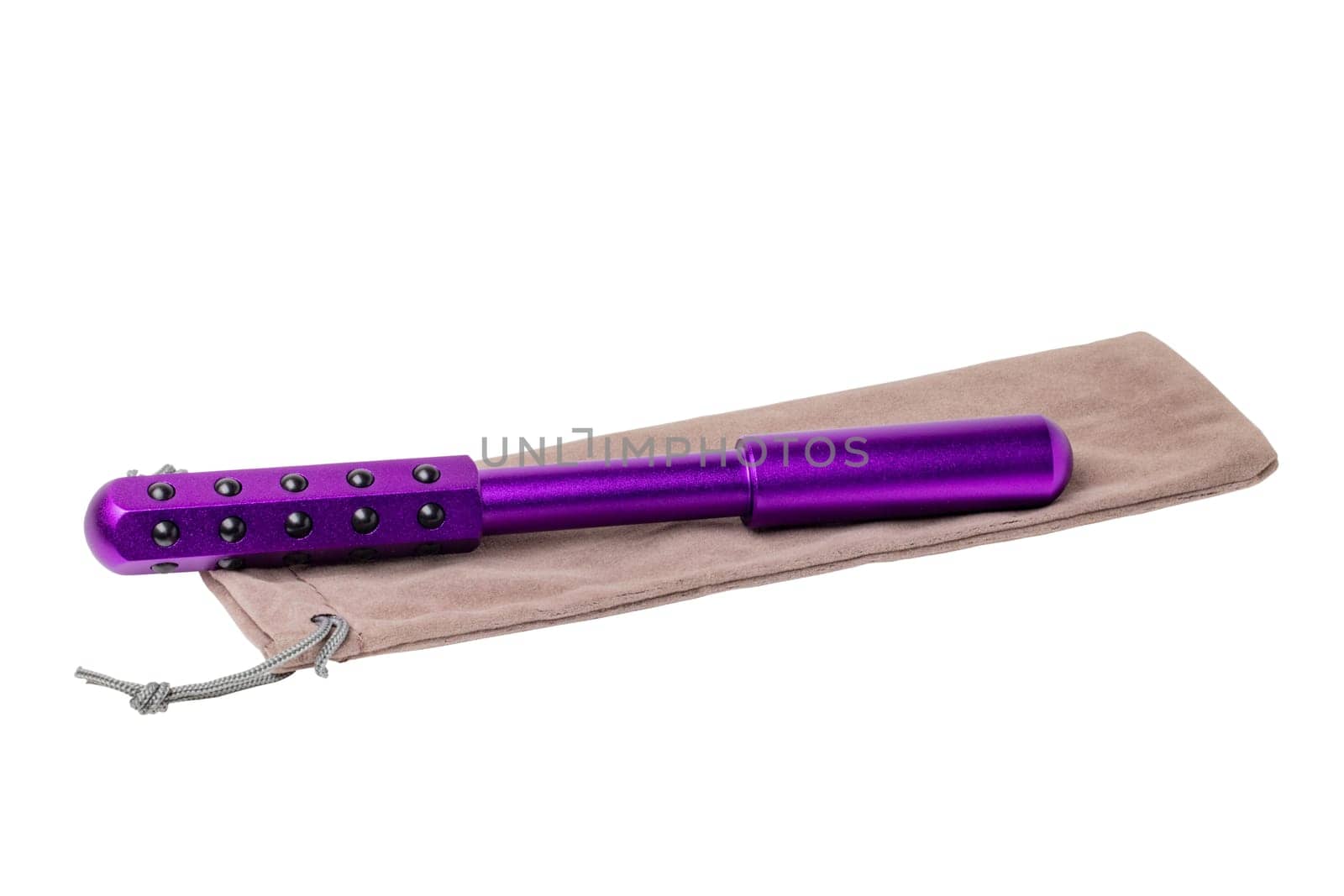 Germanium stone massage roller for face, eyes and body on a beige package. It promotes blood circulation and metabolism. Clipping path. Anti-aging, improving and tightening the skin. Beauty concept.
