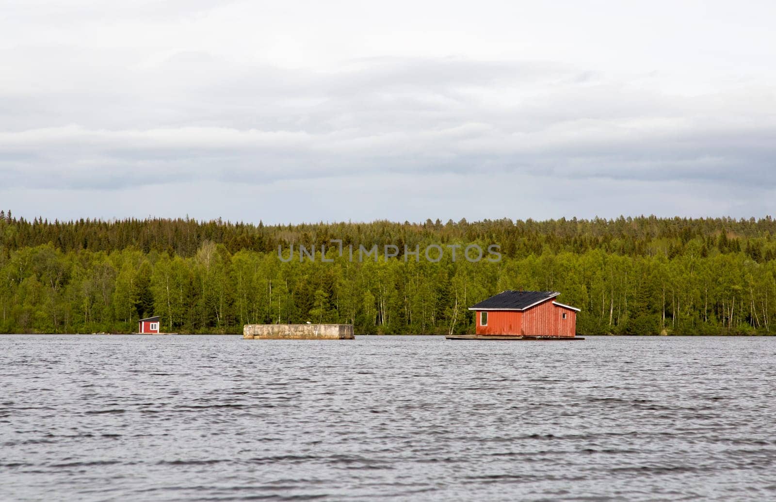 House in the middle of River in Umea, Sweden with clouds.