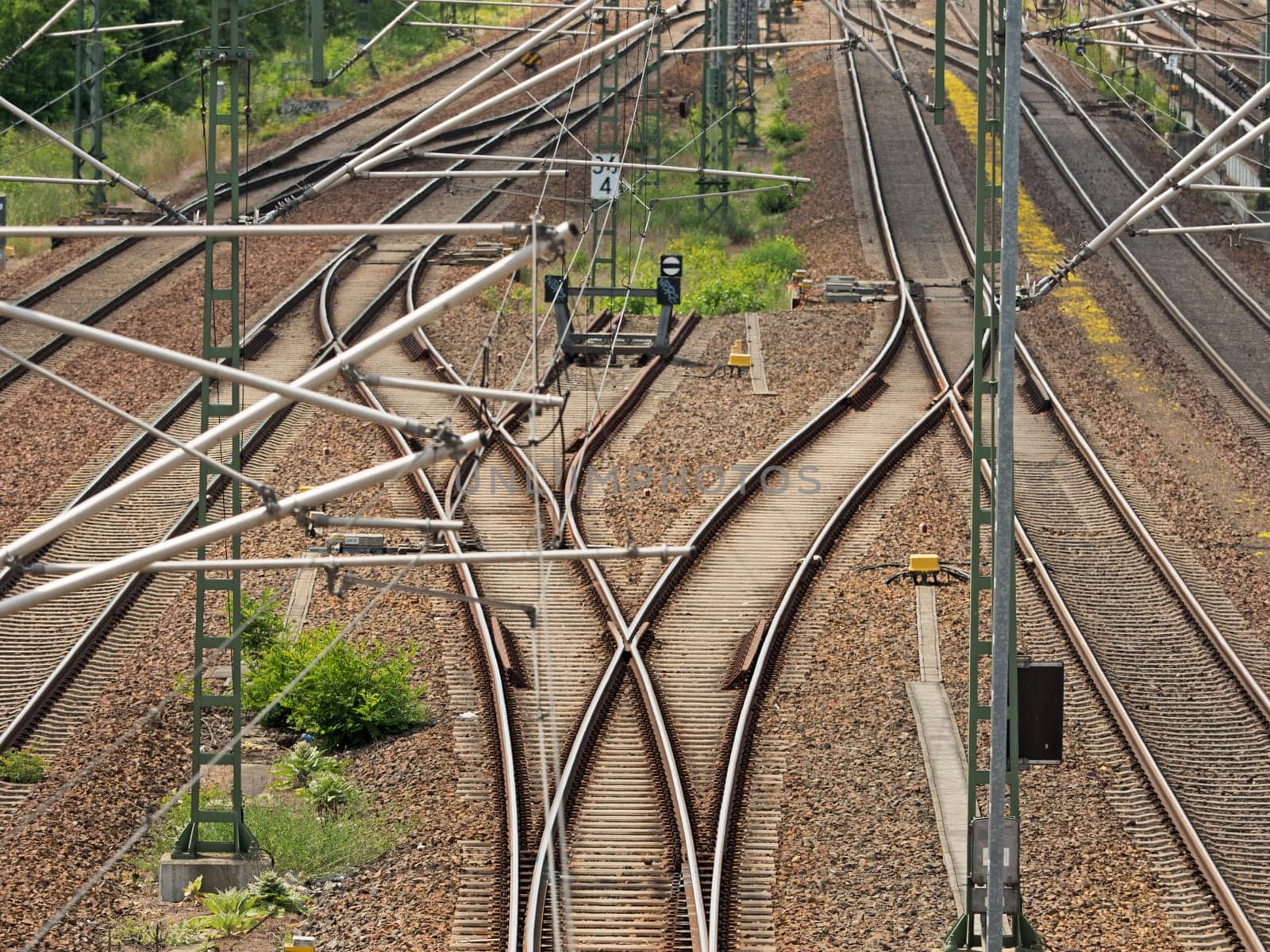 Track systems with overhead lines and switches