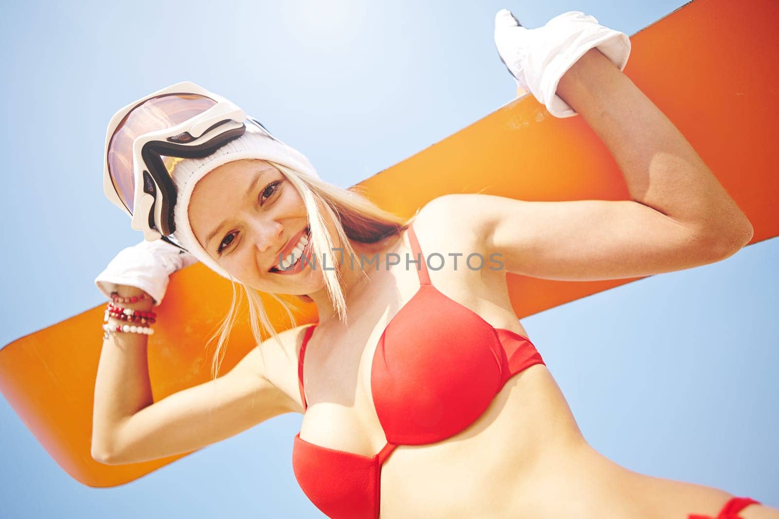 Cheerful woman with sandboard looking at camera