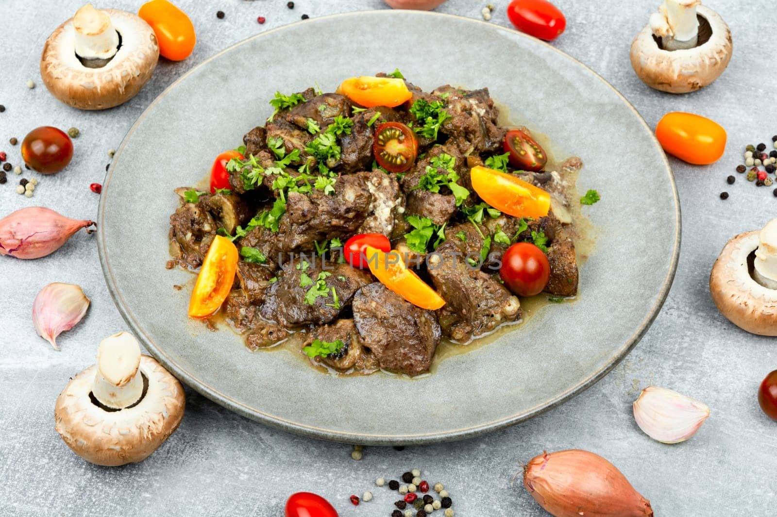 Chicken liver stewed with mushrooms and tomatoes. Georgian recipe
