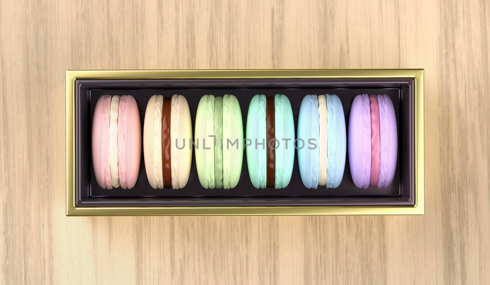 Golden box with french macarons on wooden desk