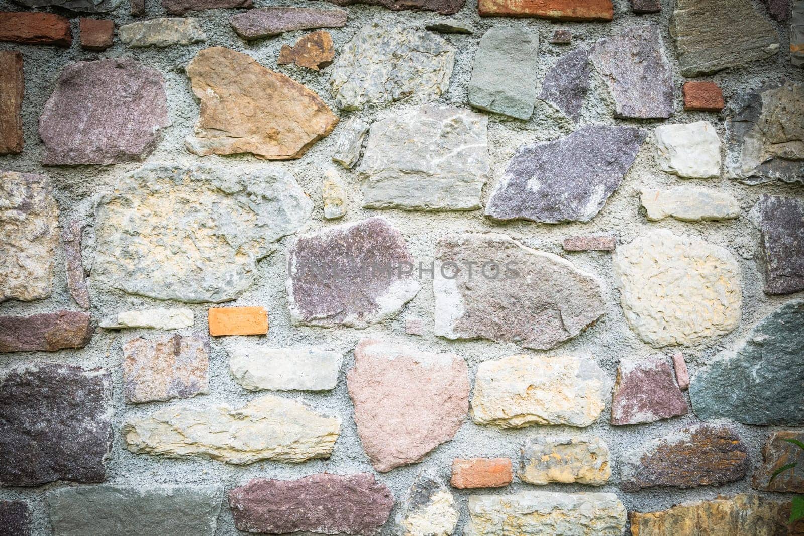Old brick wall, old texture of withe and red stone blocks closeup