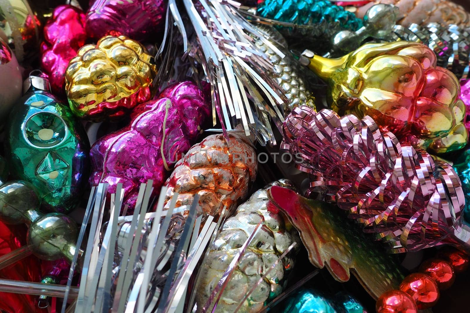 New Year and Christmas tree decorations, glass balls in the form of cones and baskets. Cones and pendants made of shiny tinsel. Festive background postcard layout blank. Lots of Christmas decorations