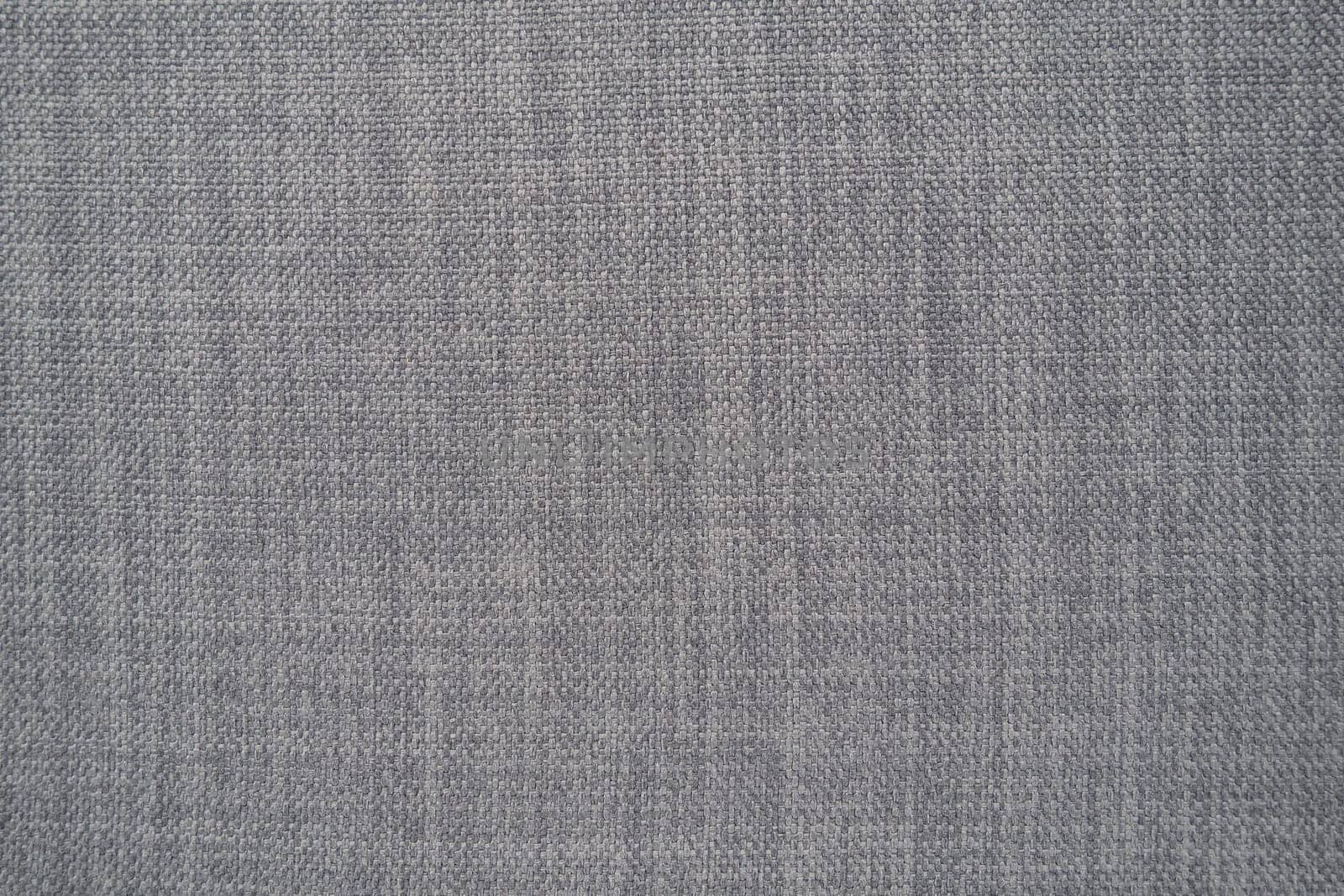 gray background fabric texture. A piece of woolen cloth is neatly laid out on the surface. Weave and textile texture. Dress fabric or for kitchen needs, tablecloth or curtains, close-up. Dash.