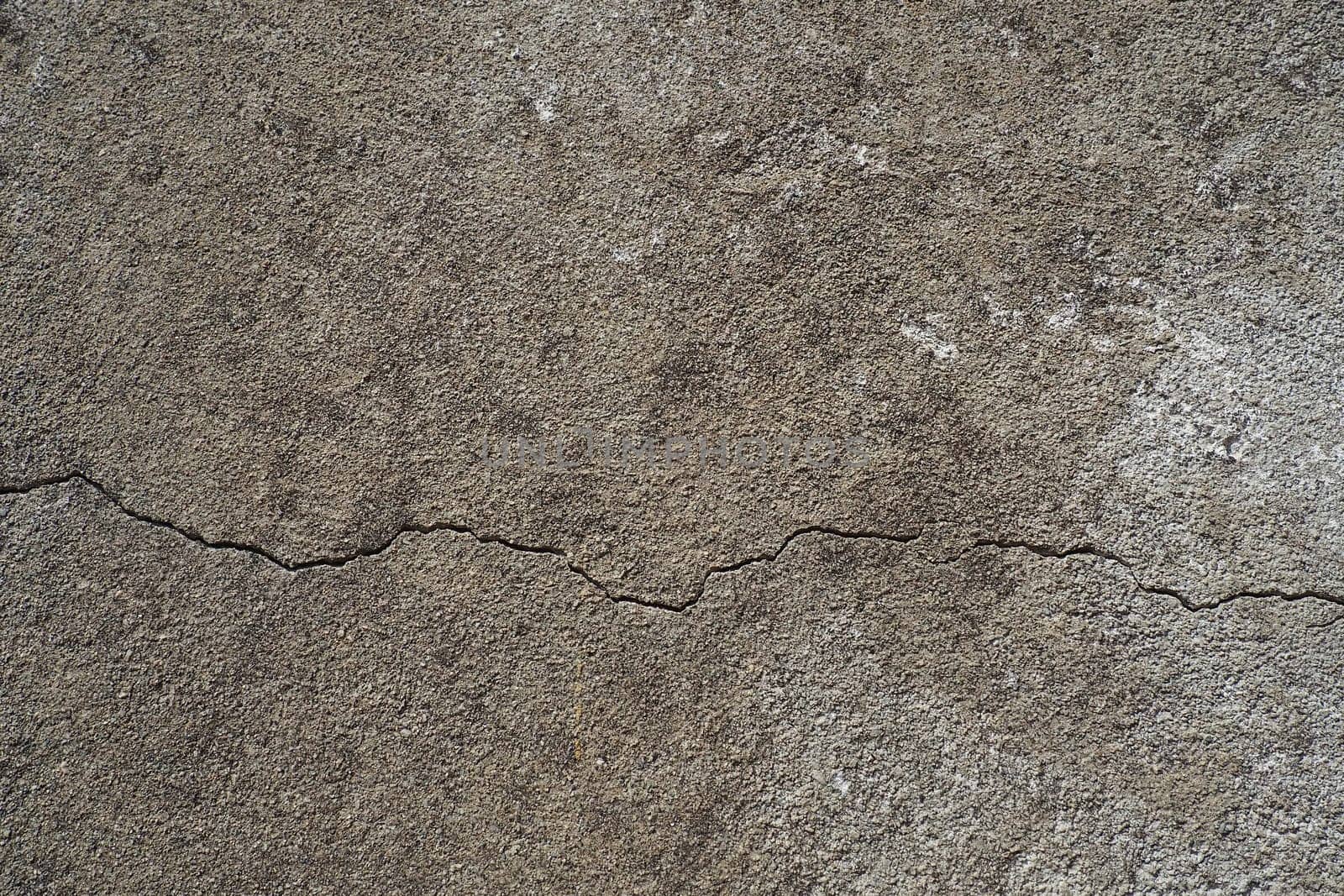 Plastered wall texture. Whitewash surface. Abstract background. Retro wall built structure texture. Cracks and bumps on the concrete wall. Uneven coloring with water-based paint. Old tattered plaster.
