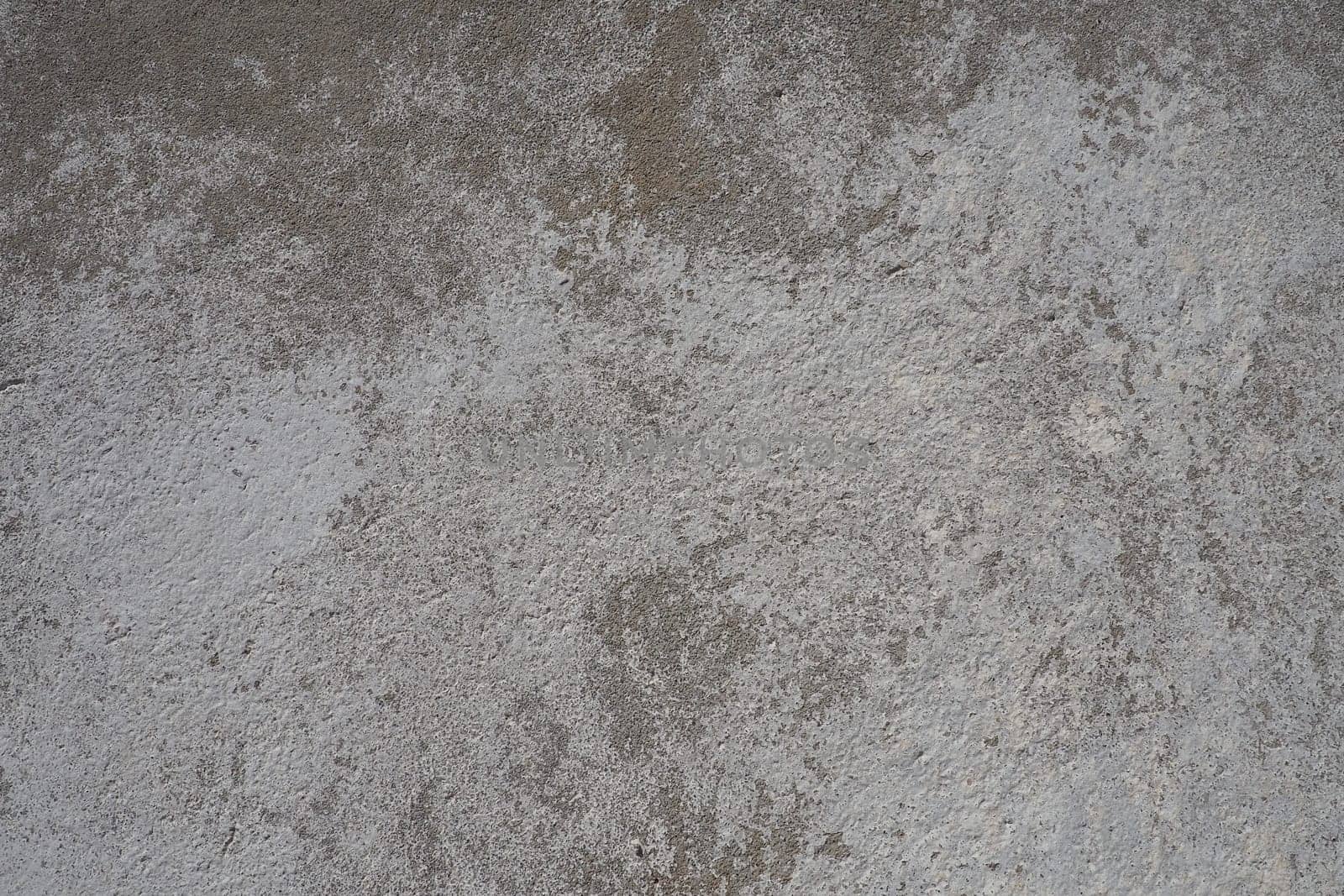 Plastered wall texture. Whitewash surface. Abstract background. Retro wall built structure texture. Cracks and bumps on the concrete wall. Uneven coloring with water-based paint. Old tattered plaster.