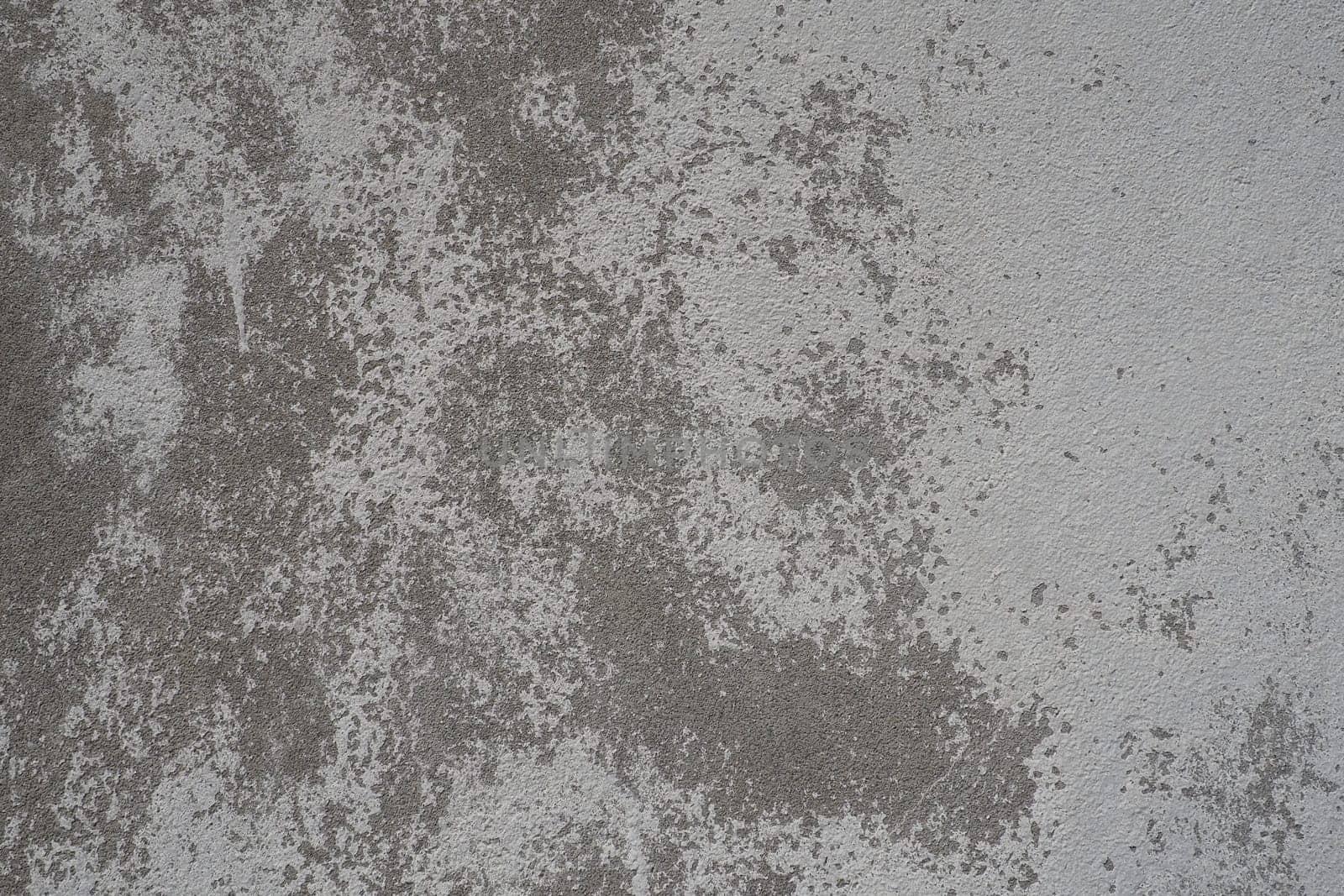 Plastered wall texture. Whitewash surface. Abstract background. Retro wall built structure texture. Cracks and bumps on the concrete wall. Uneven coloring with water-based paint. Old tattered plaster.