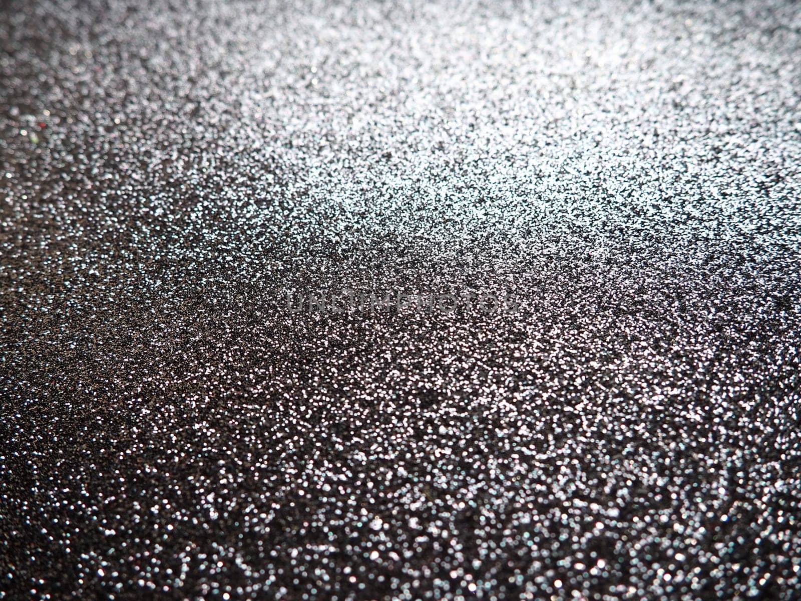 Purple shiny bokeh abstract background. Blue - lilac paper with sparkles. Festive backdrop.