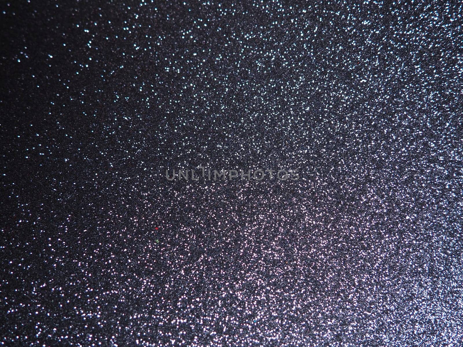 Purple shiny bokeh abstract background. Blue - lilac paper with sparkles. Festive backdrop.