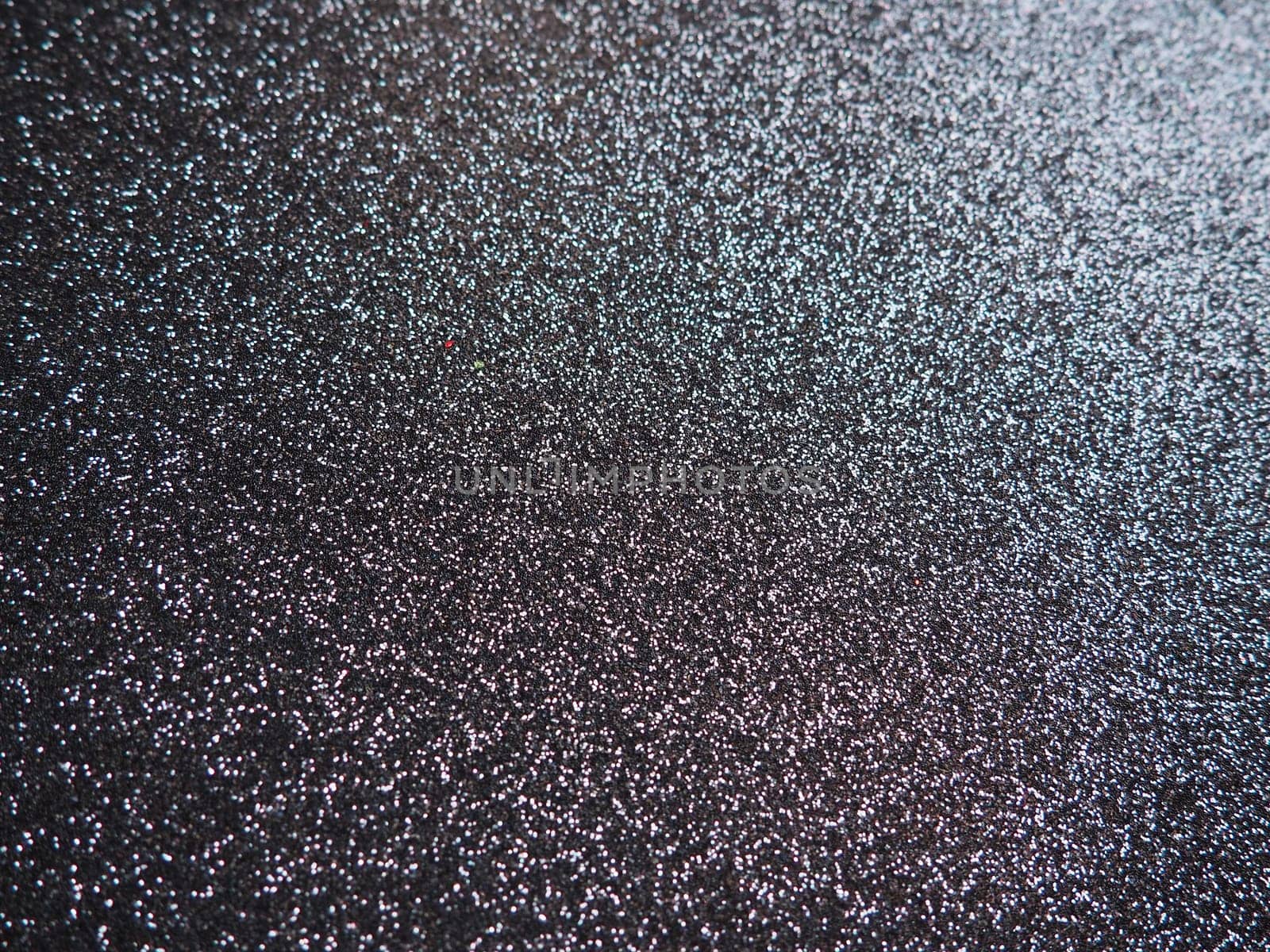 Purple shiny bokeh abstract background. Blue - lilac paper with sparkles. Festive backdrop.