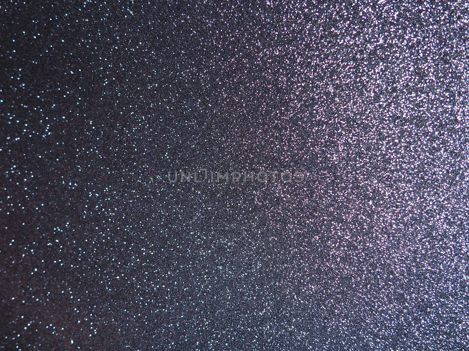 Purple shiny bokeh abstract background. Blue - lilac paper with sparkles. Festive backdrop.