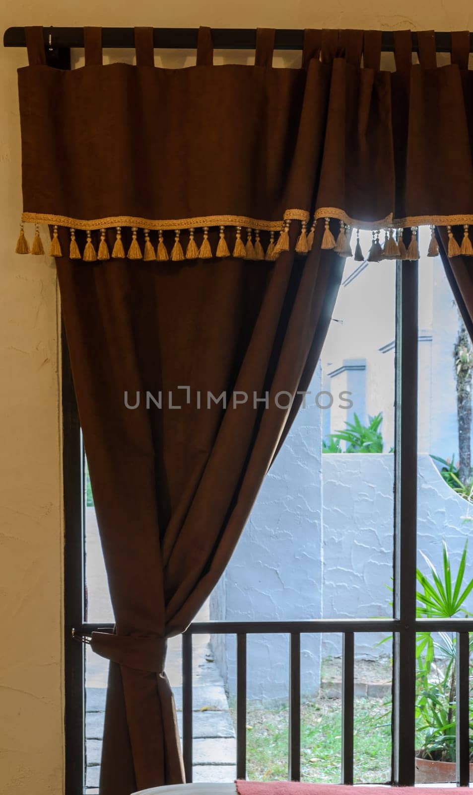 Glass window with brown velvet curtain