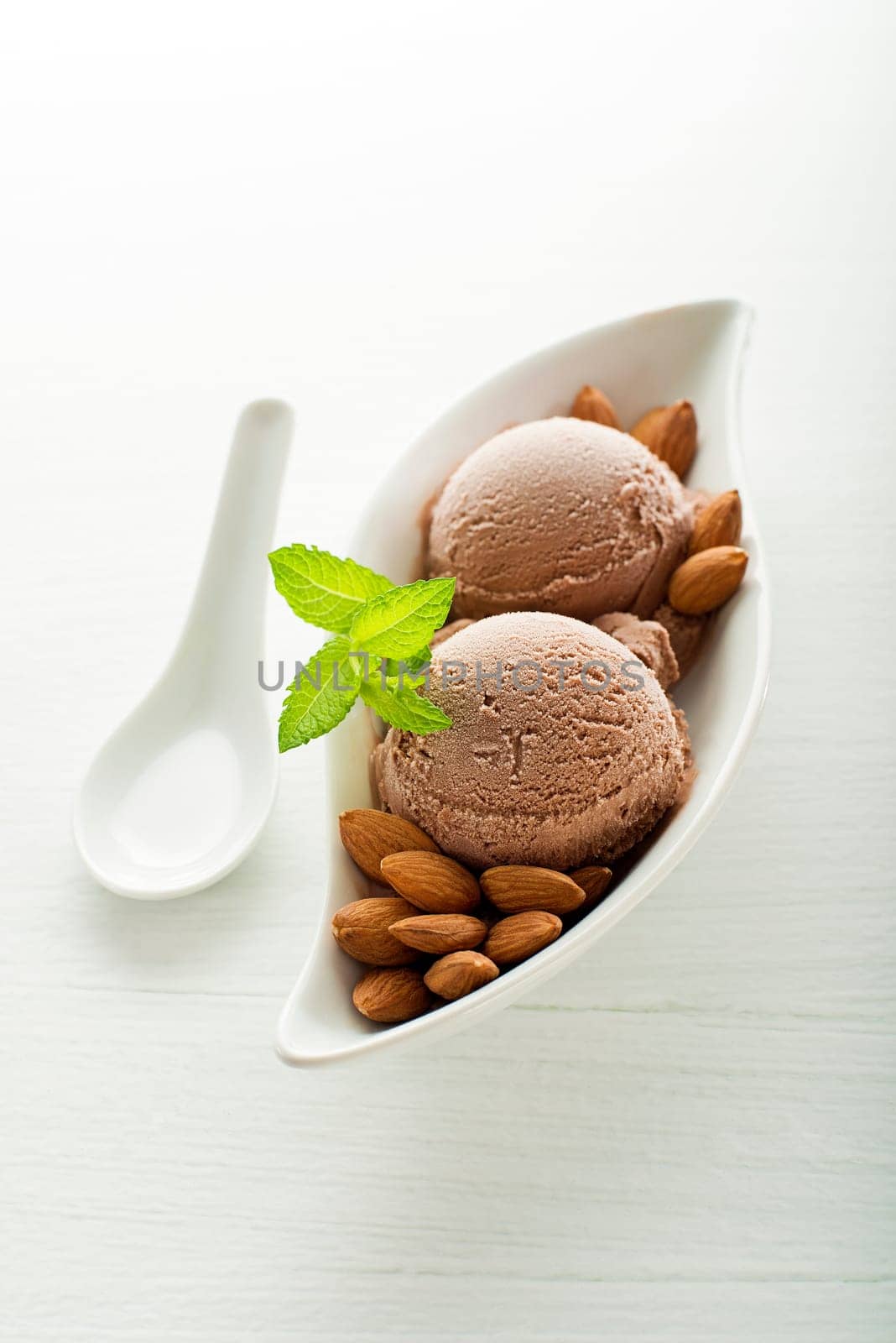 Fresh almond ice cream on white plate close up