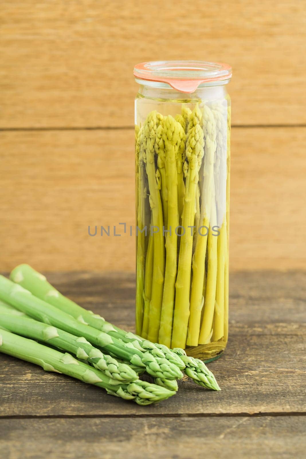Fresh green asparagus and boiled asparagus in the glass