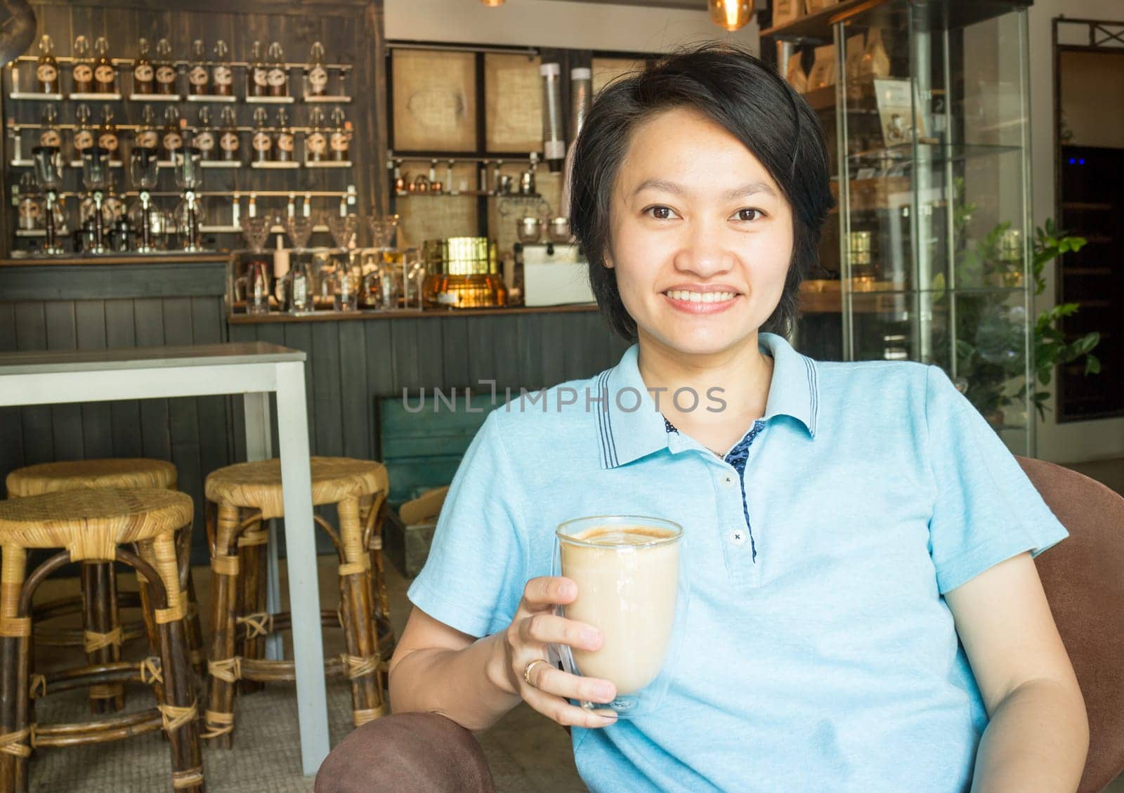 Customer enjoying hot coffee latte, stock photo