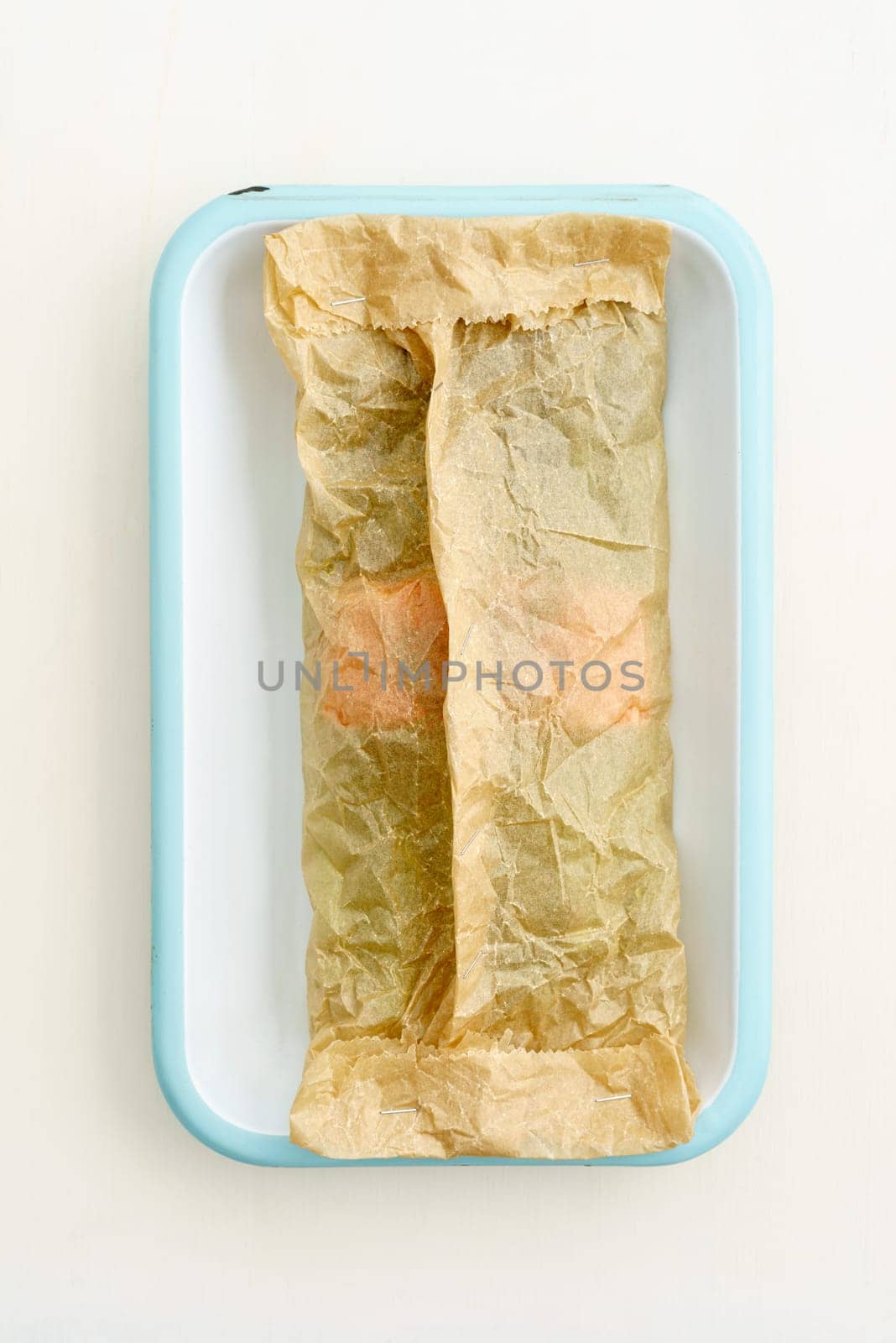 Green asparagus with salmon for baking with baking paper in a baking dish