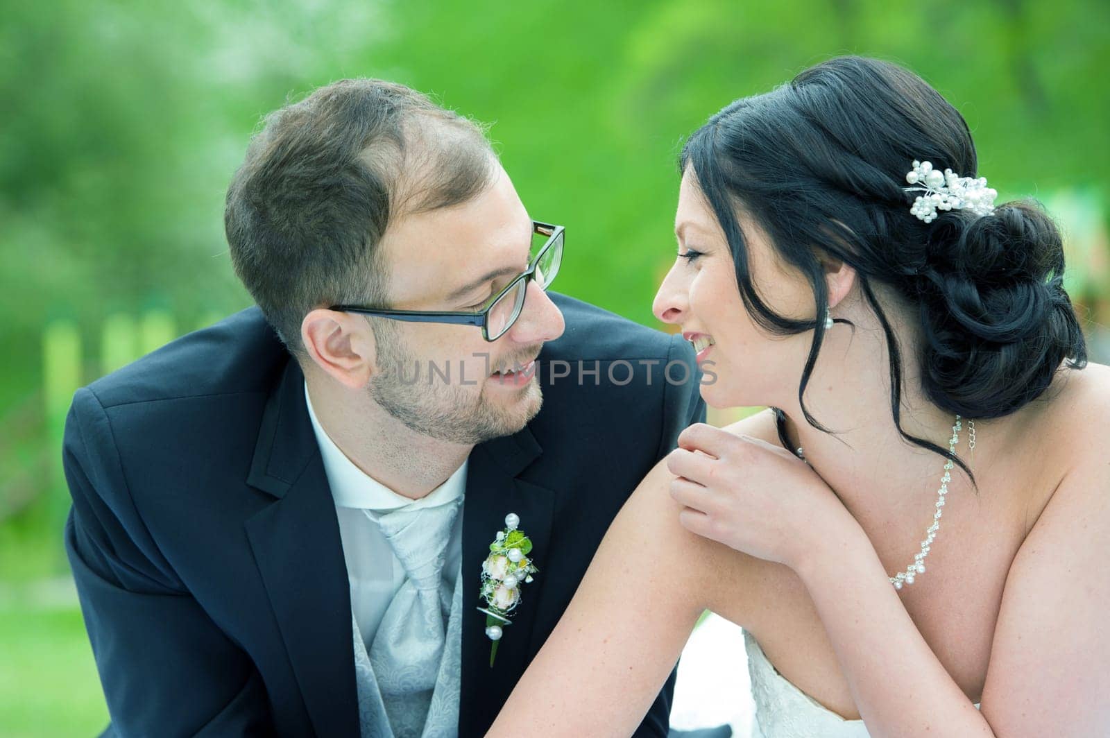 young bridal couple together in front of nature background