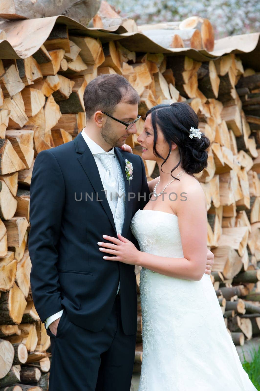 young bridal couple together in front of wooden background