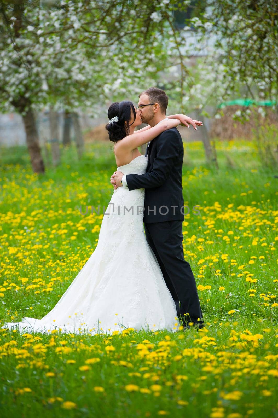 young bridal couple together in front of nature background