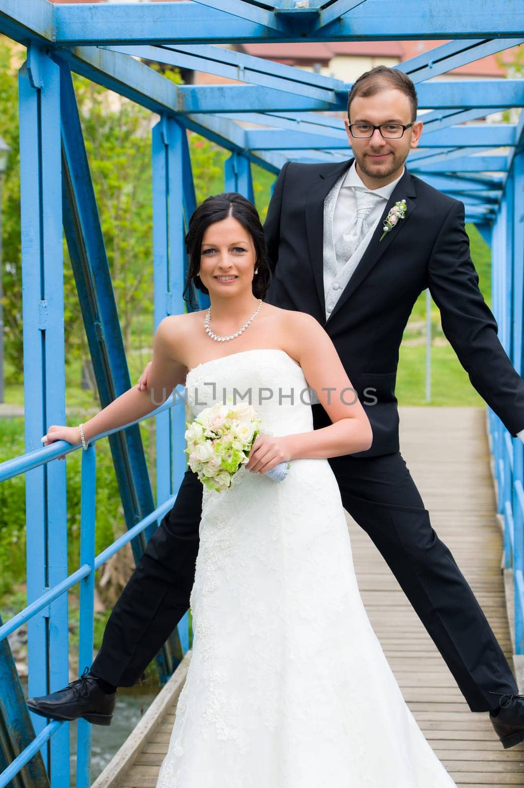 young bridal couple together in front of nature background