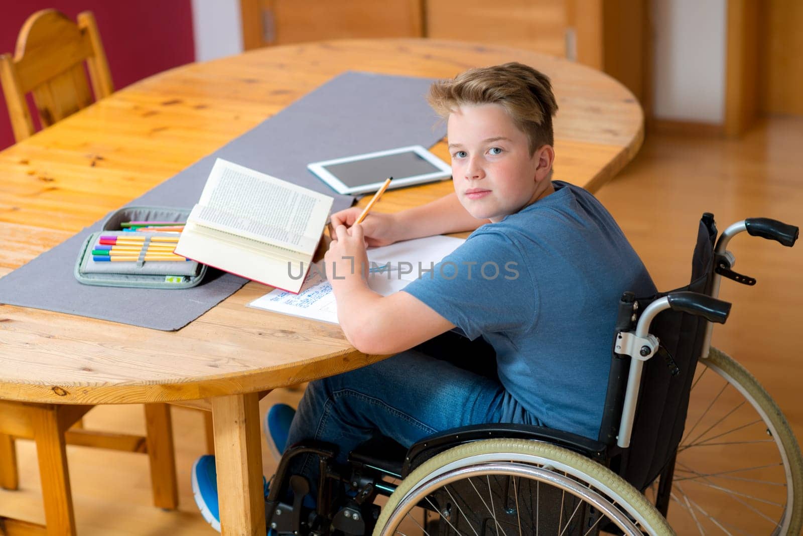 disabled boy in wheelchair doing homework