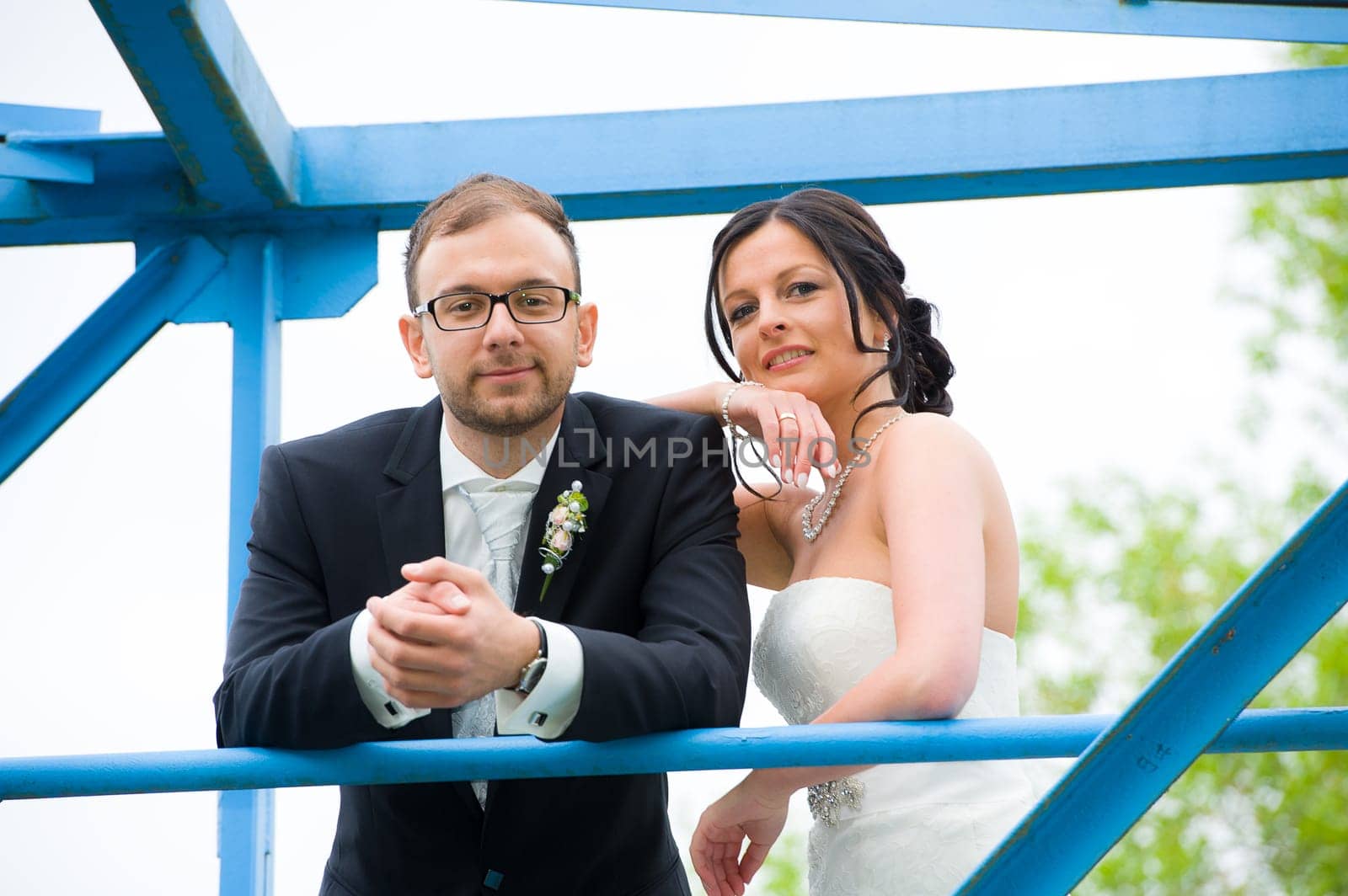 young bridal couple together in front of nature background