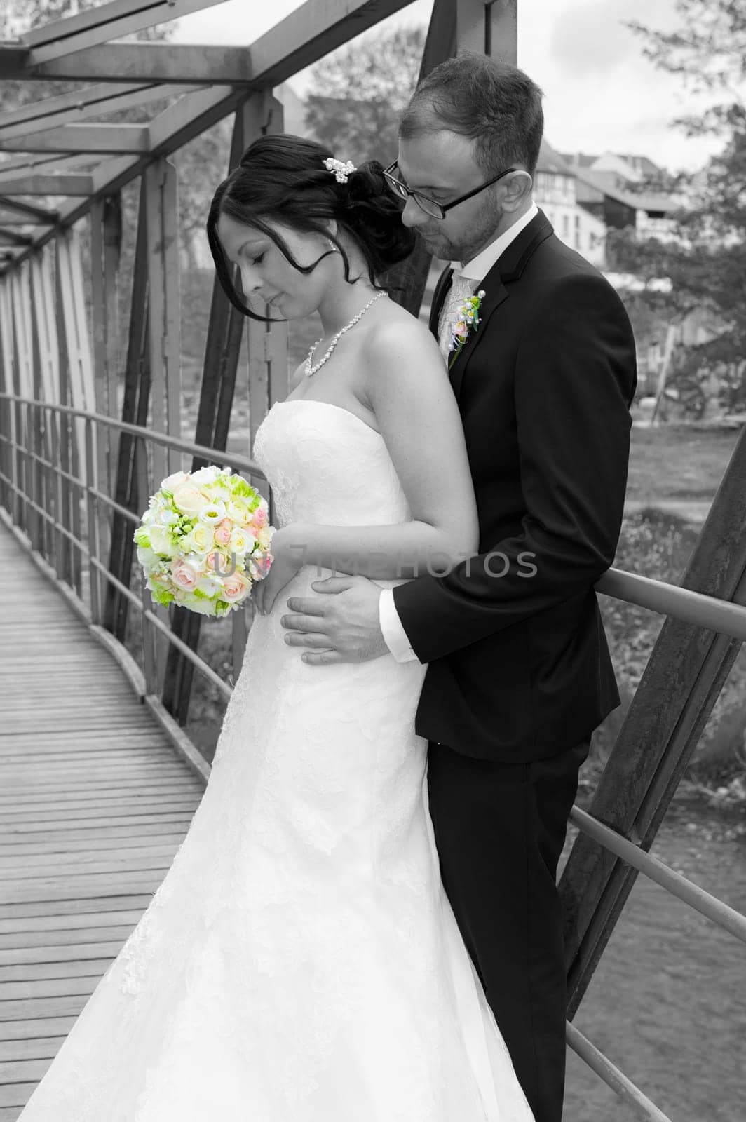 young bridal couple together in front of nature background