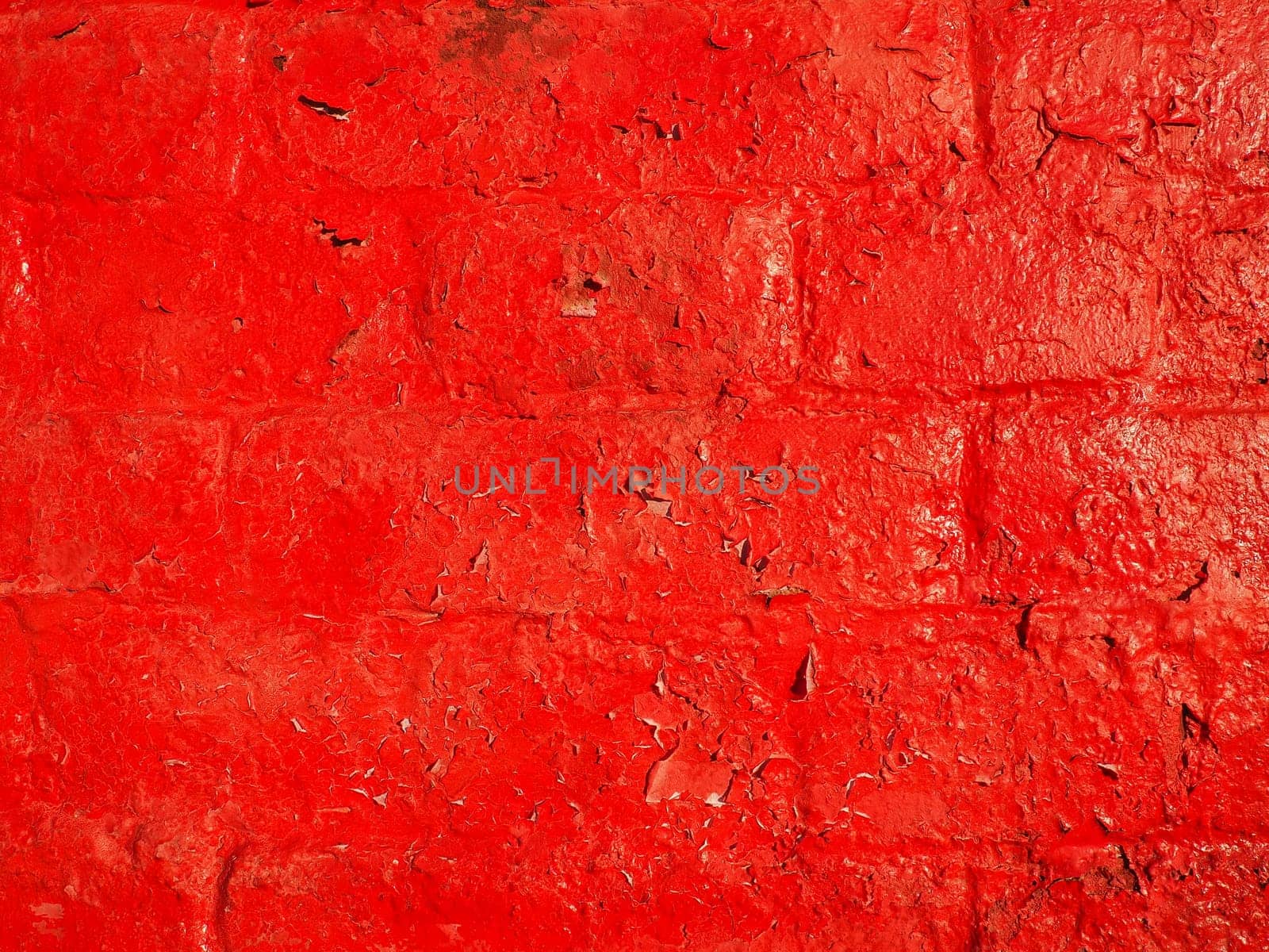 Red wall and texture background. Large bricks painted with glossy oil scarlet paint