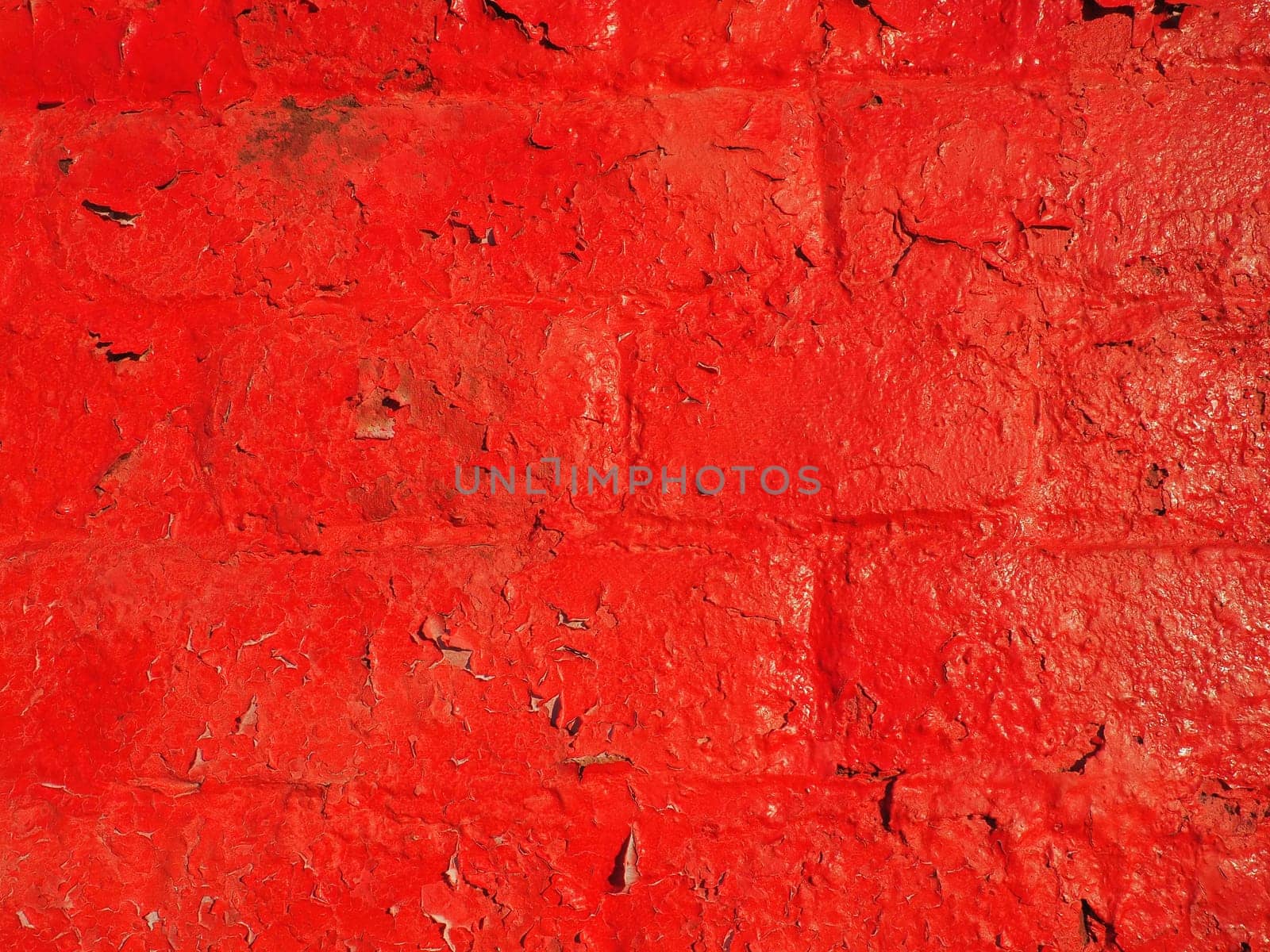 Red wall and texture background. Large bricks painted with glossy oil scarlet paint