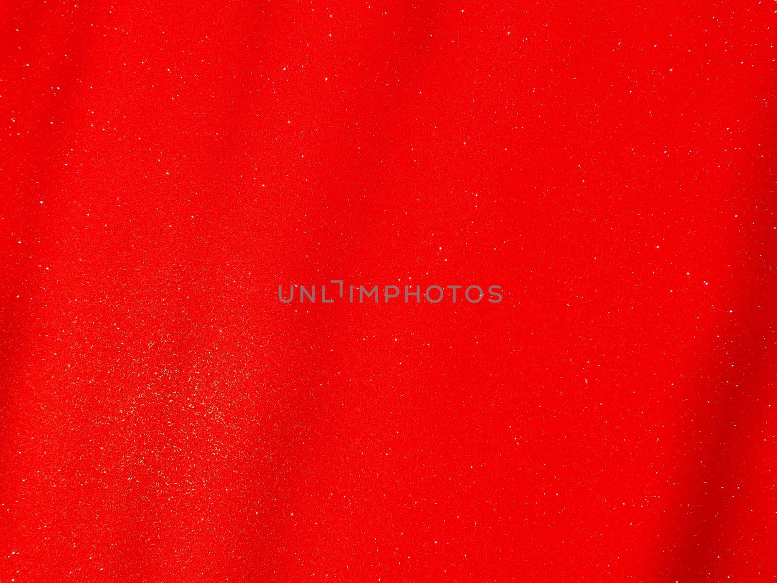 Red background, arched scarlet. Nice holiday color. Background with shimmer, gradient, white dots. Photograph of sparkling colored paper