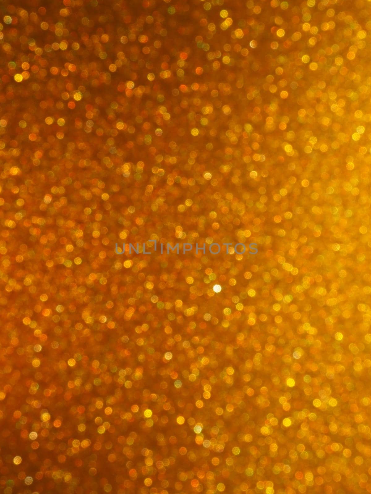 Bokeh light of gold glitters. Golden glitter texture background. Sparkling glitter wrapping paper with sequins and sparkles. Festive golden bokeh and glitter. Beautiful background