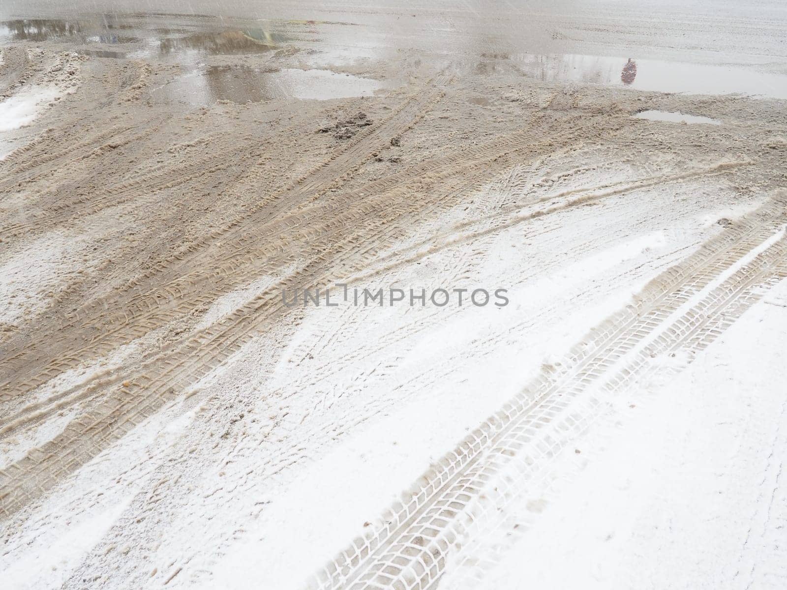 A fork or siding from a roundabout. Snowdrifts on the side of the road. Bad weather and traffic. Snow on asphalt. Difficult driving conditions. Winter slosh on the road. Braking distance of a car.