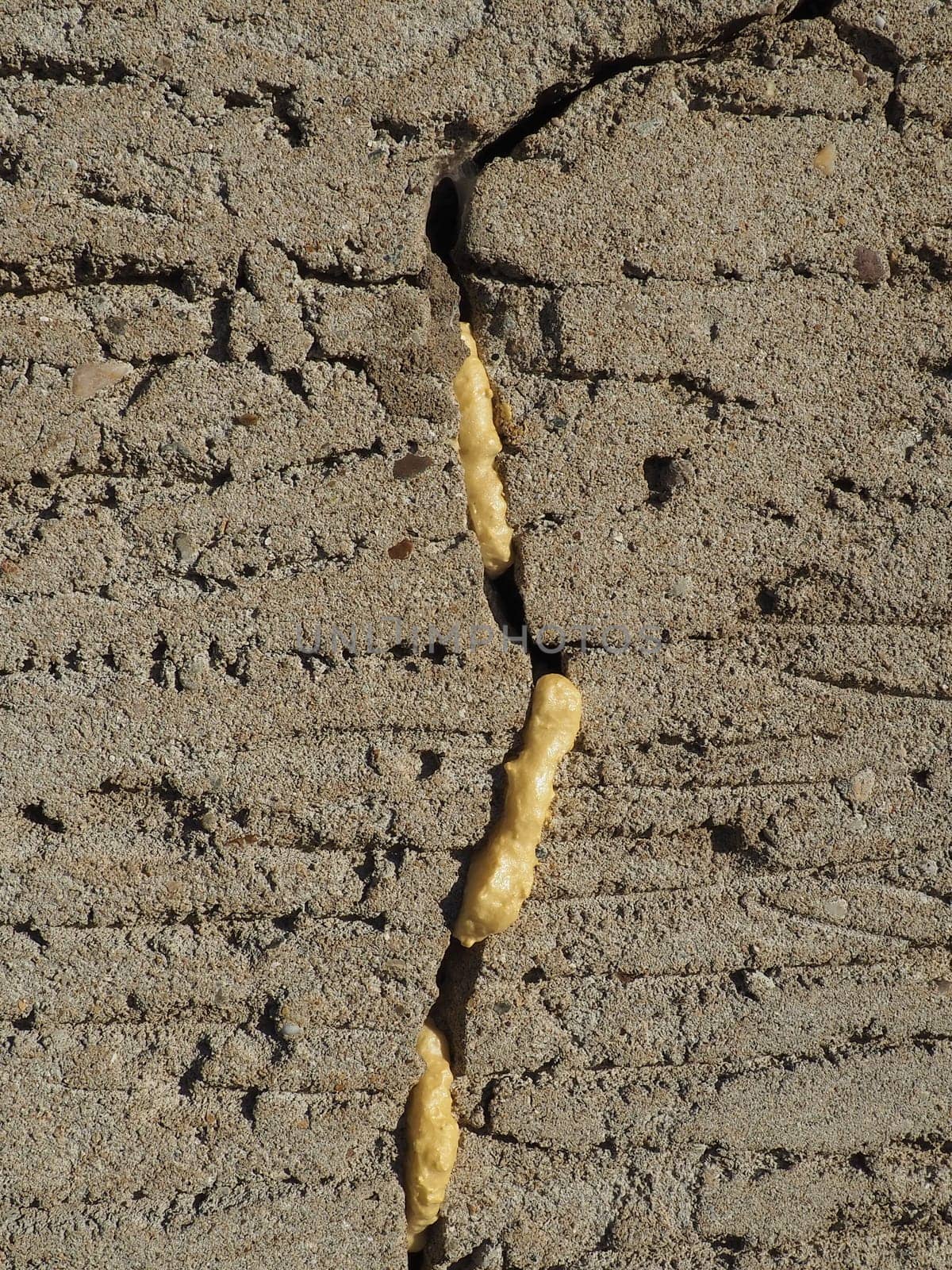 Mounting foam - polyurethane foam sealant. The foam consists of 2 main components, Methylene diphenyl diisocyanate and polyols. Foam-filled crack in the plastered wall of the facade of the house