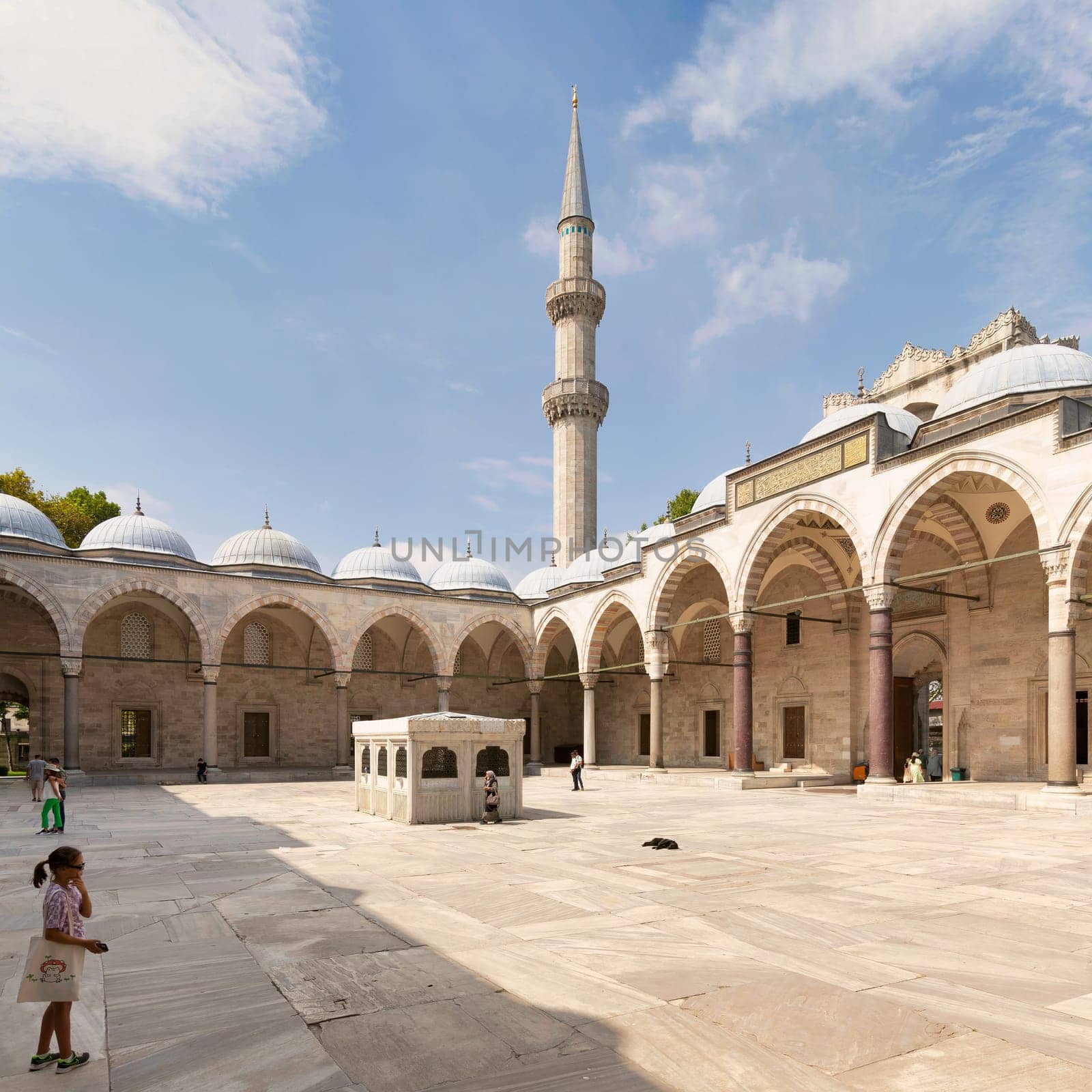 Istanbul, Turkey - August 26, 2022: Courtyard of Suleymaniye Mosque with few tourists walking around, an Ottoman imperial mosque located on the Third Hill of Istanbul