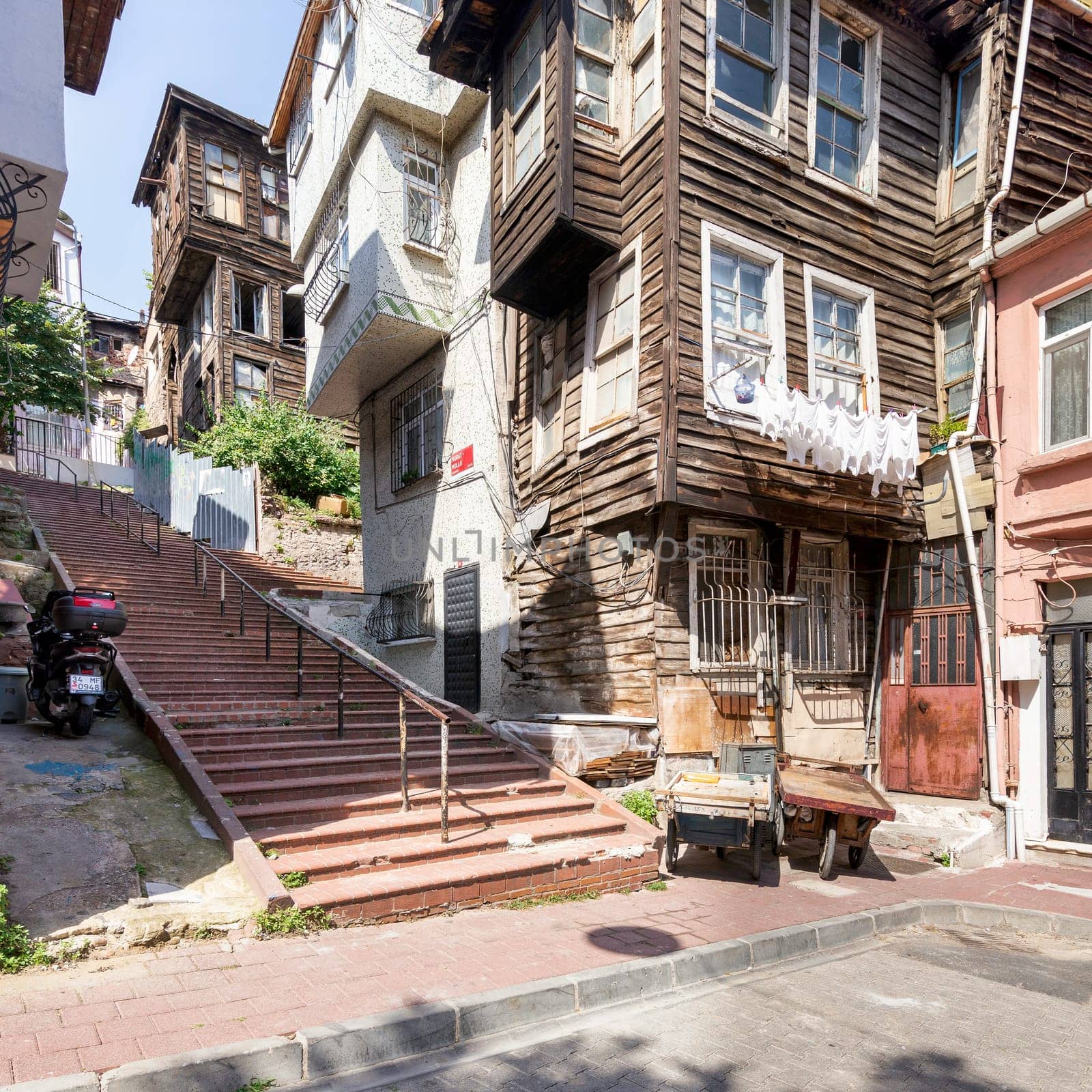 Beautiful old traditional wooden and stone houses, and stone staircase, in old Balat district, on a summer day, Istanbul, Turkey