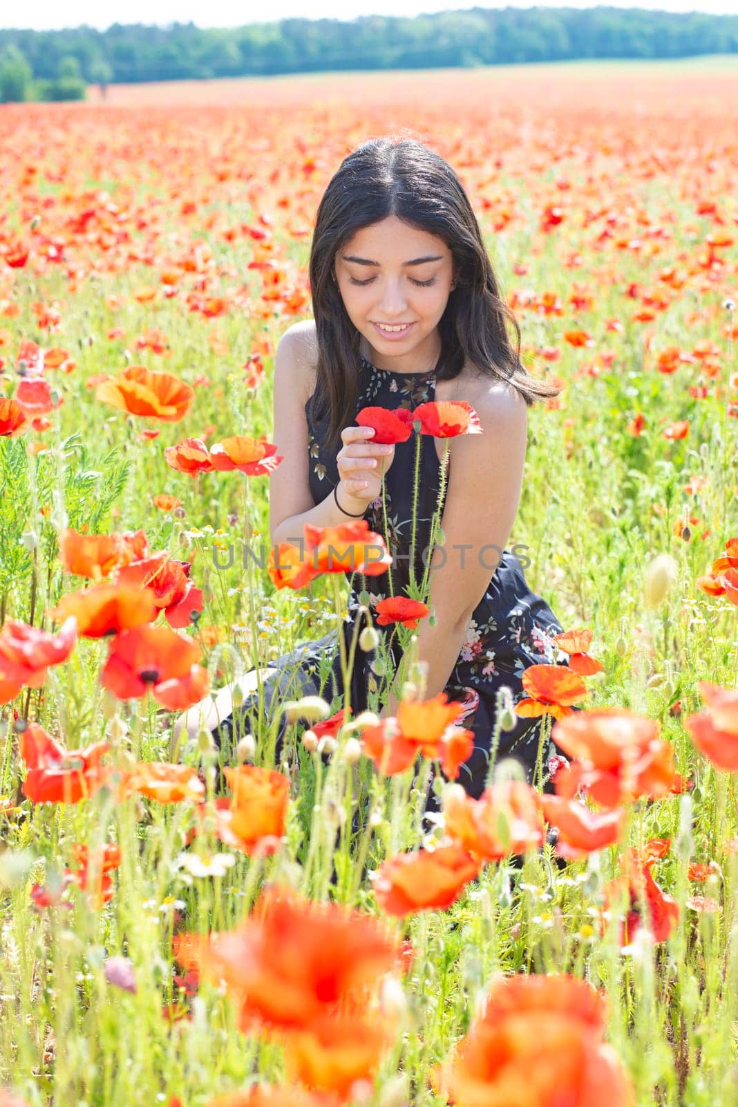 happy young woman in poppy field