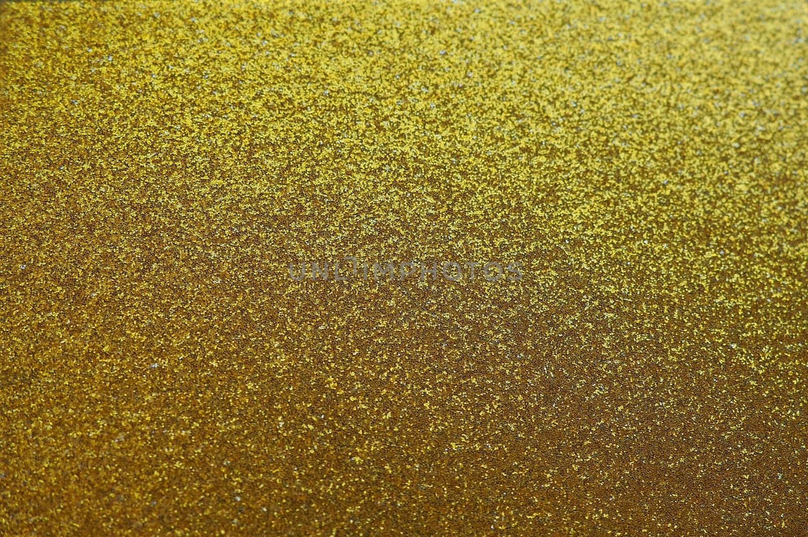 Gold close up. Golden glitter texture background. Sparkling glitter wrapping paper with sequins and sparkles. Festive golden bokeh and glitter. Beautiful background. Bokeh light of gold glitters.