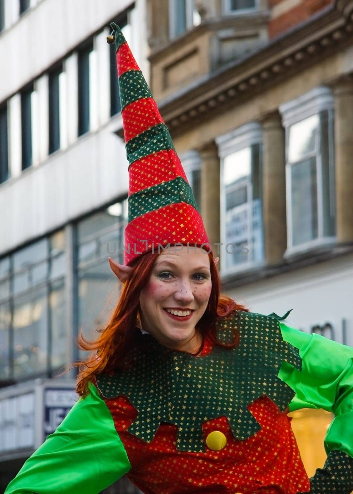 London, United Kingdom - December 2nd, 2006: Unknown woman dressed in Christmas elf costume posing for tourists during "Oxford Street closed for traffic"" event."