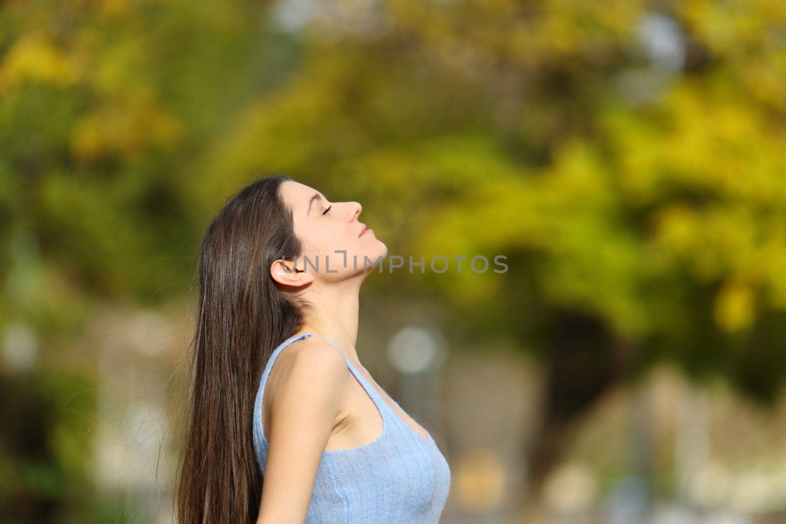 Profile of a teen breathing fresh air in a park
