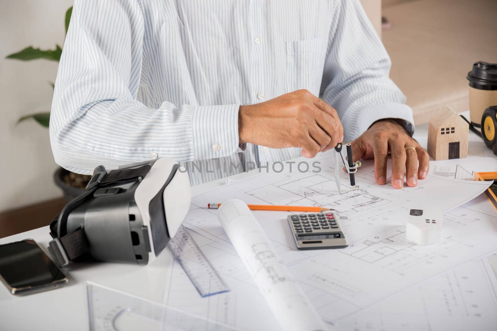 Architect workplace. Architectural building design and construction plans with blueprints paper project plans and VR glasses, designing man edit a building or architecture drawing with compass divider